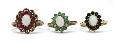 Lot 1385 - A 9ct gold opal and sapphire cluster ring