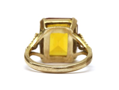 Lot 1241 - A gold single stone synthetic orange sapphire ring