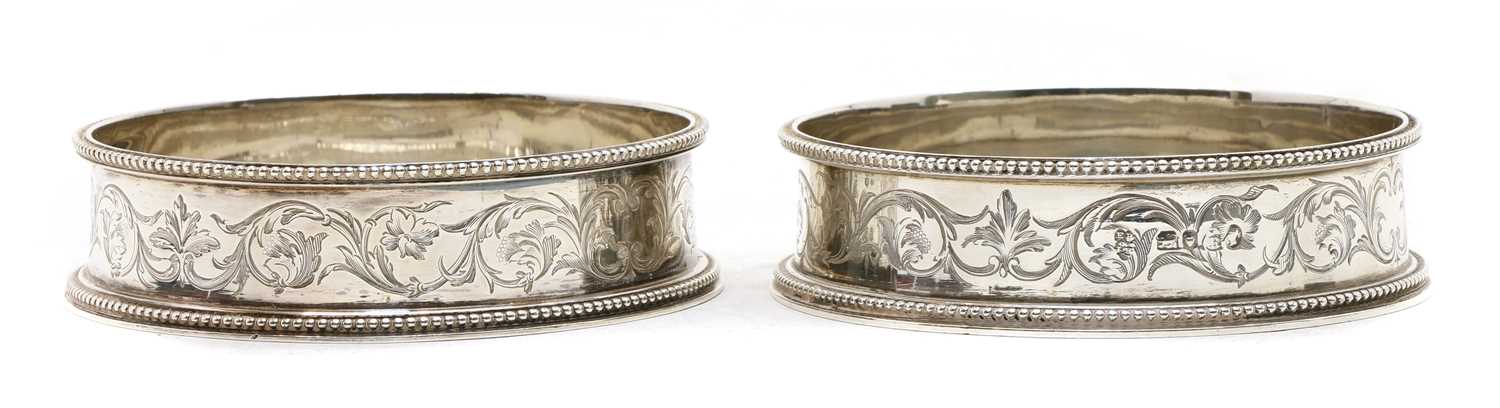 Lot 108 - A pair of Victorian silver coasters