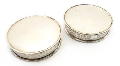 Lot 108 - A pair of Victorian silver coasters