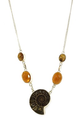 Lot 1333 - A silver ammonite, glass and tiger's eye necklace