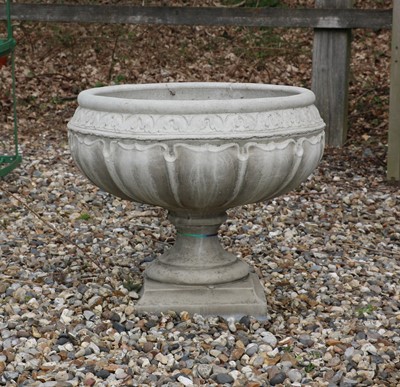 Lot 475 - A composite stone garden urn