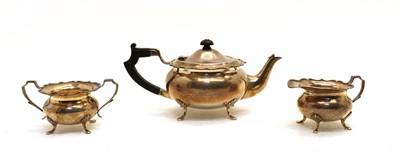 Lot 125 - A silver three piece teaset comprising teapot