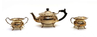 Lot 125 - A silver three piece teaset comprising teapot