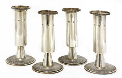 Lot 654 - A set of four silver candlesticks