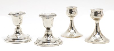Lot 122 - Two pairs of silver candlesticks