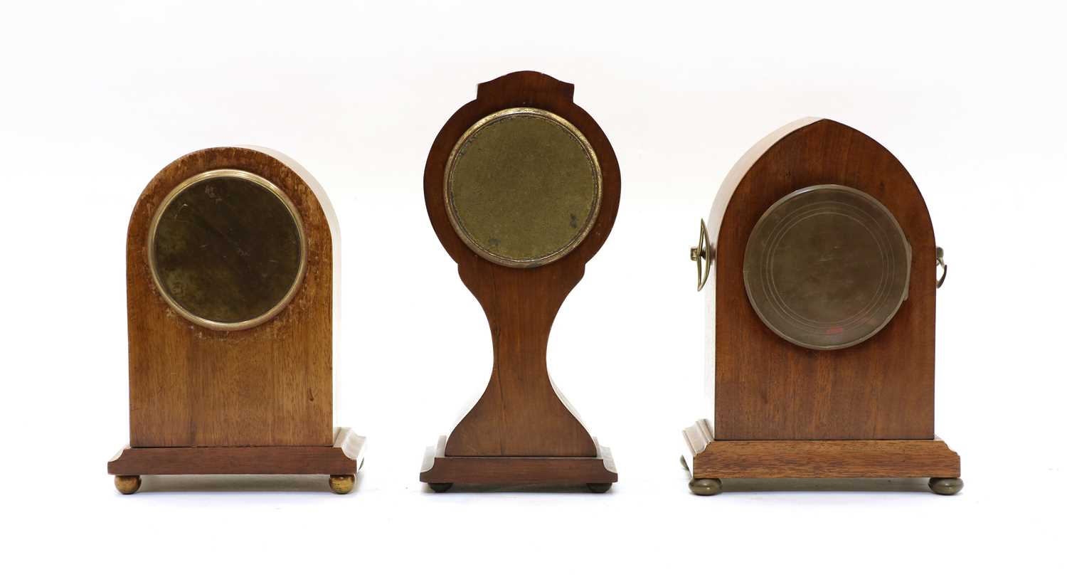 Lot 203 An Edwardian walnut lancet shaped mantle