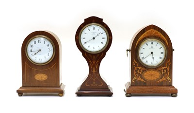 Lot 203 - An Edwardian walnut lancet shaped mantle clock