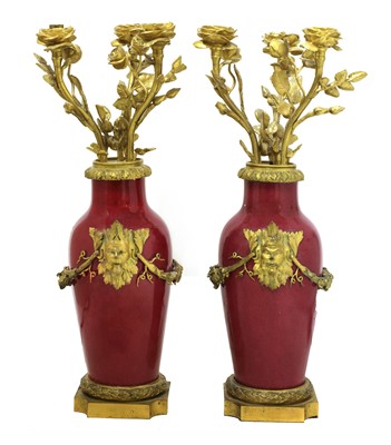Lot 59 - A pair of ormolu-mounted pink ground vase lamps