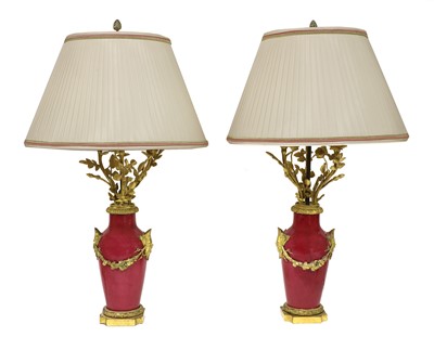 Lot 59 - A pair of ormolu-mounted pink ground vase lamps
