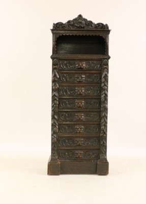 Lot 389 - A late Victorian carved ebonised oak Wellington chest of drawers