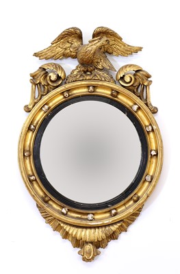 Lot 665 - A Regency period circular gilt eagle wall mirror