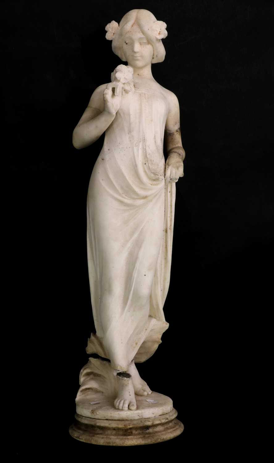 Lot 161 - A white marble figure of a lady holding flowers