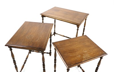 Lot 485 - A nest of three oak occasional tables