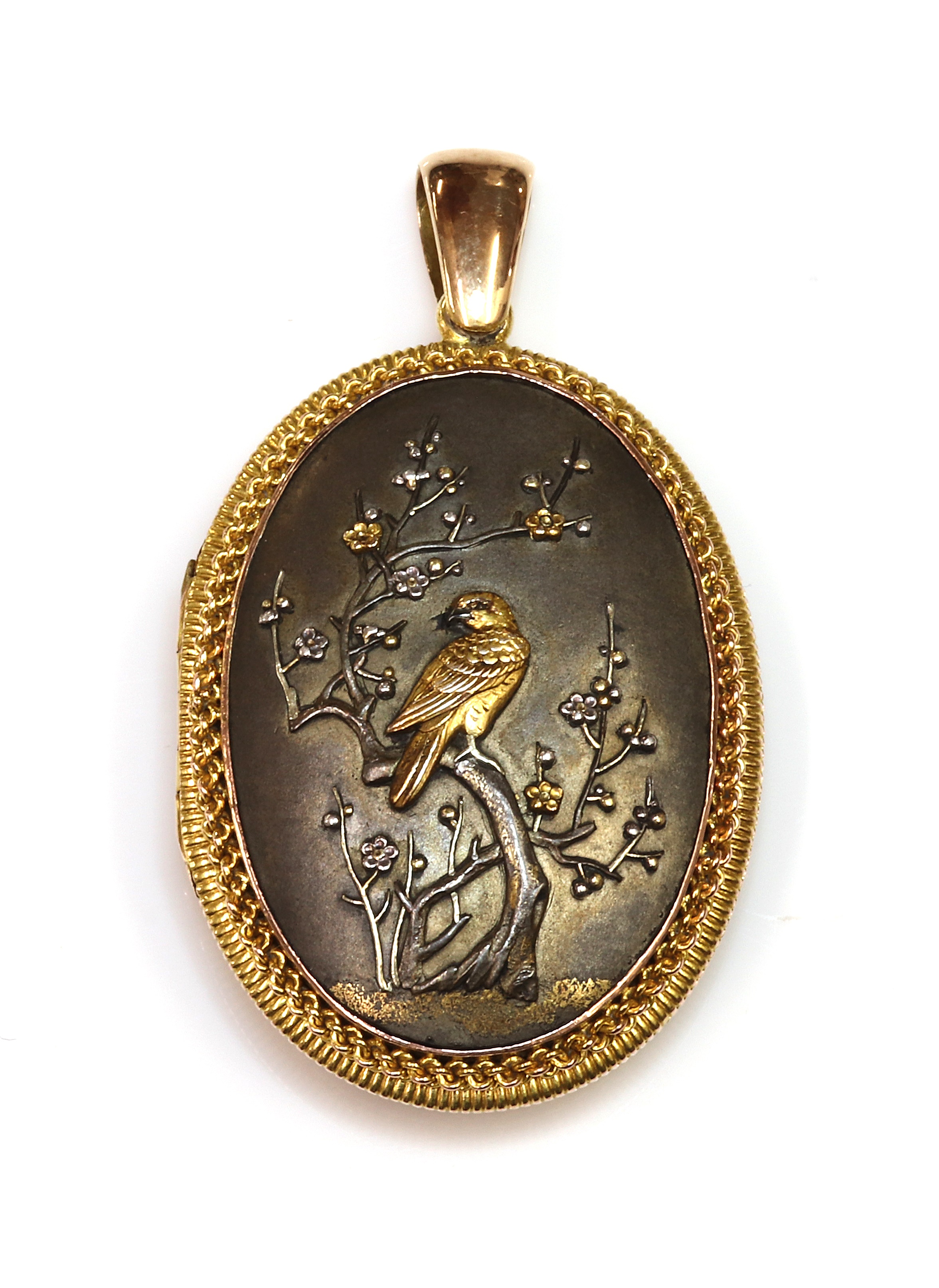 Lot 83 - A Shakudo double sided oval hinged locket,