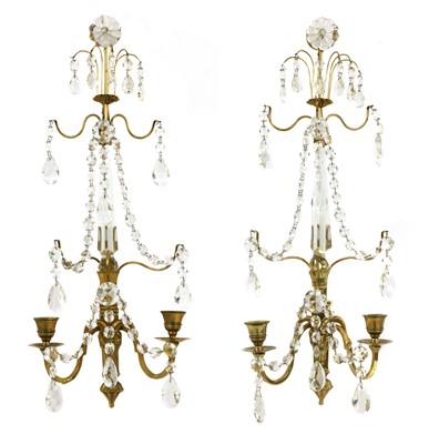 Lot 650 - A pair of Continental polished brass and cut-glass wall lights with lustres