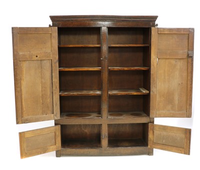 Lot 425 - A panelled oak cupboard