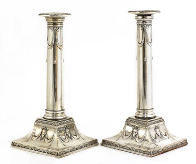 Lot 497 - A pair of Edwardian silver-plated neoclassical candlesticks
