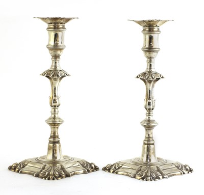 Lot 504 - A pair of cast silver table candlesticks