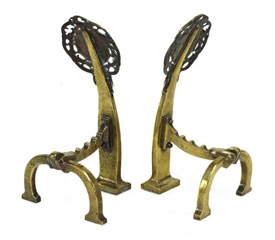 Lot 94 - A pair of Arts and Crafts pierced brass firedogs