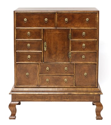 Lot 435 - A walnut chest on stand