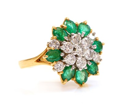 Lot 354 - A two colour gold, diamond and emerald cluster ring