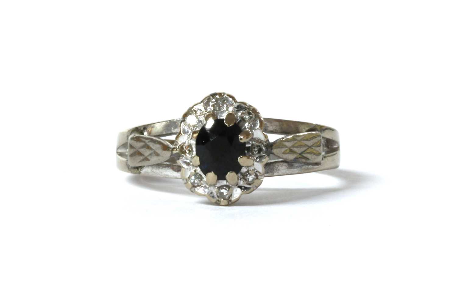 Lot 125 - An 18ct white gold sapphire and diamond cluster ring