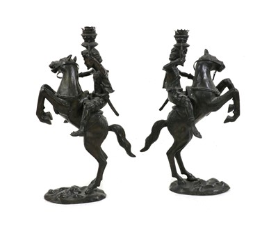 Lot 375 - A pair of patinated bronze oil lamps