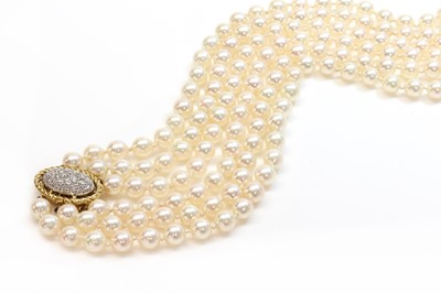 Lot 215 - A three row uniform cultured pearl necklace