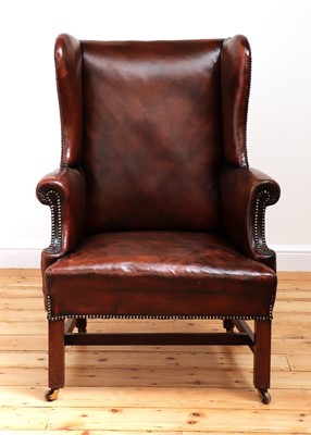 Lot 560 - A George III mahogany-framed leather wingback armchair