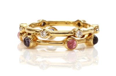 Lot 368 - Two gold diamond and gem set stacking rings, by Ilias Lalaounis