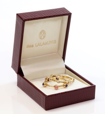 Lot 368 - Two gold diamond and gem set stacking rings, by Ilias Lalaounis