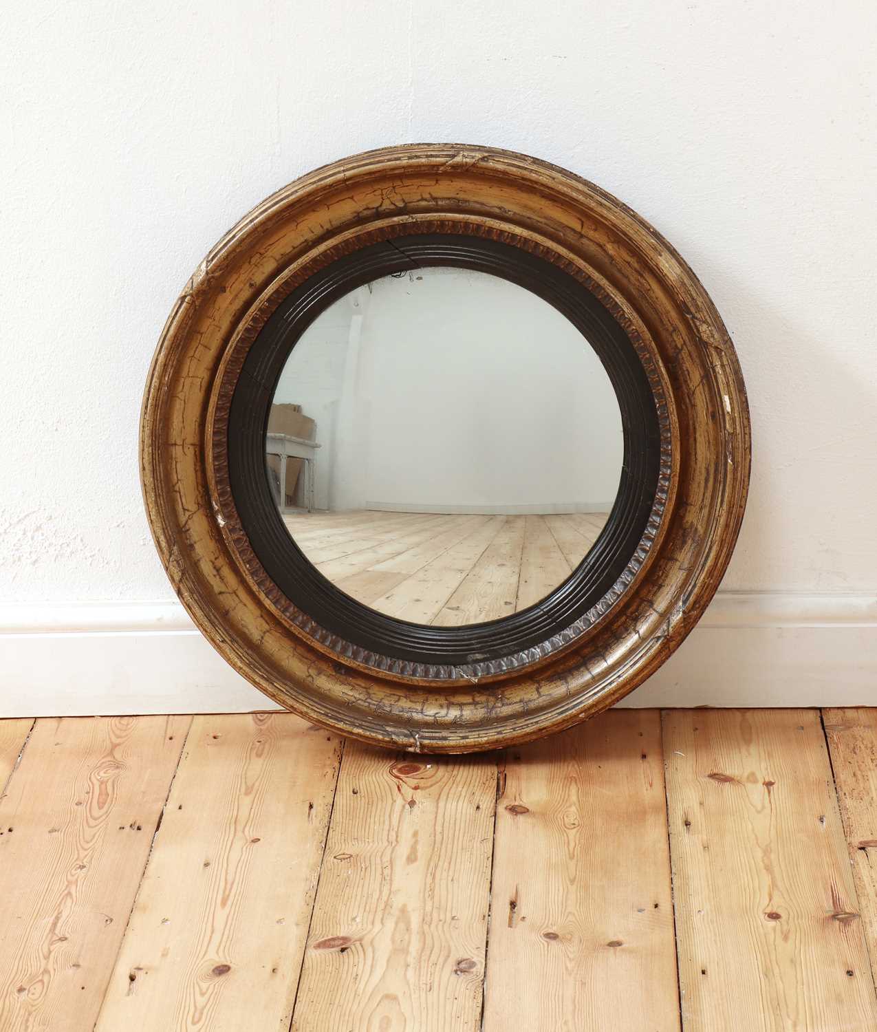 Lot 459 - A Regency gilt-framed convex wall mirror