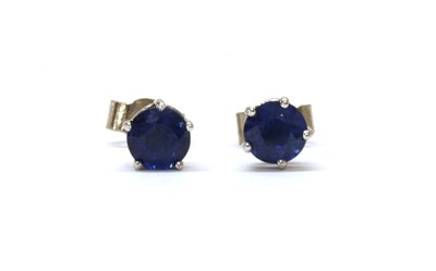 Lot 1281 - A pair of 18ct white gold single stone sapphire stud earrings