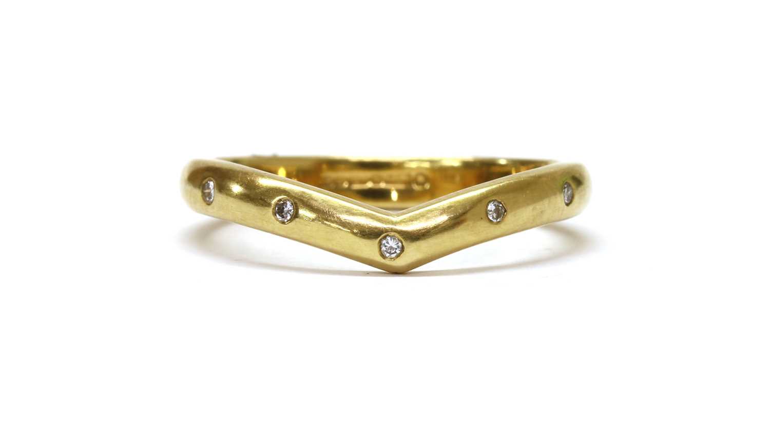 Lot 1177 - An 18ct gold diamond set wishbone ring