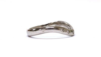 Lot 1208 - An 18ct white gold diamond set shaped band ring