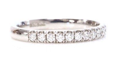 Lot 434 - An 18ct white gold diamond set half eternity ring