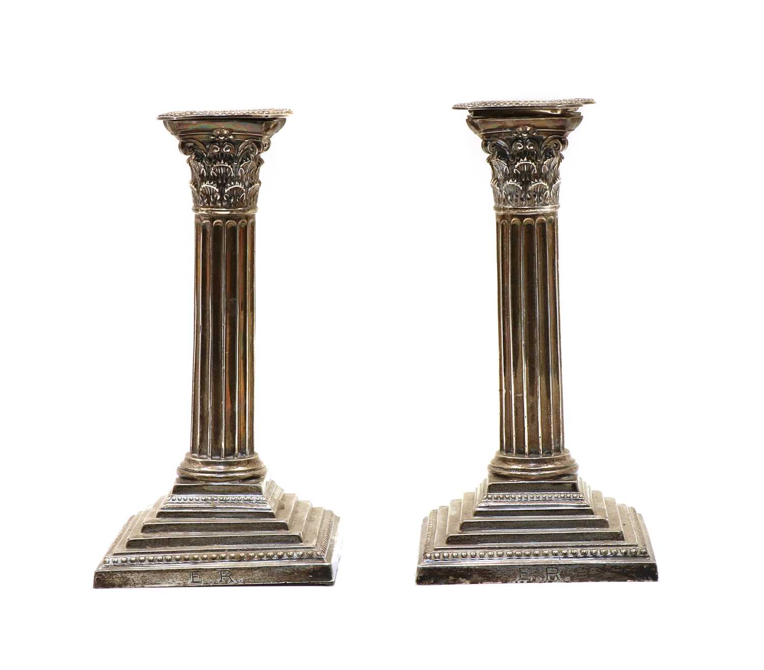 Lot 7 - A pair of silver Corinthian column candlesticks
