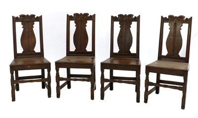 Lot 314 - A set of four 18th century and later carved oak chairs