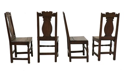 Lot 314 - A set of four 18th century and later carved oak chairs