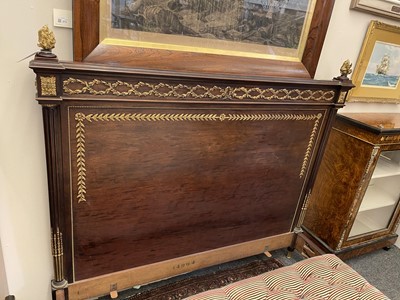 Lot 570 - A Louis XVI-style plum pudding mahogany double bed