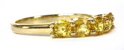 Lot 166 - A gold five stone yellow sapphire ring