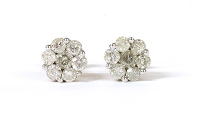 Lot 57 - A pair of gold diamond daisy cluster earrings