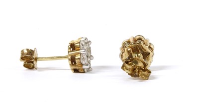 Lot 57 - A pair of gold diamond daisy cluster earrings