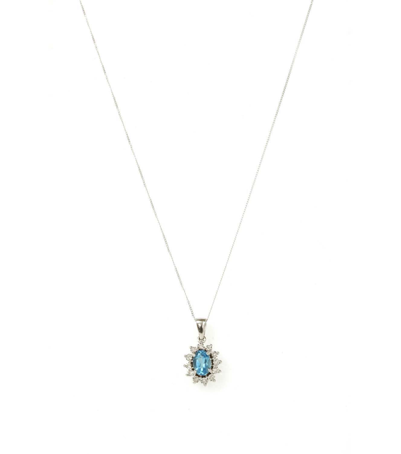 Lot 134 - A white gold blue topaz and diamond cluster pendant