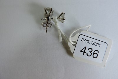 Lot 436 - A pair of white gold single stone diamond earrings
