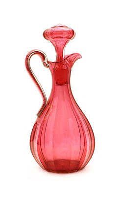 Lot 106 - A Victorian cranberry glass jug with stopper