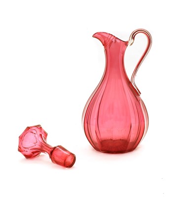 Lot 106 - A Victorian cranberry glass jug with stopper