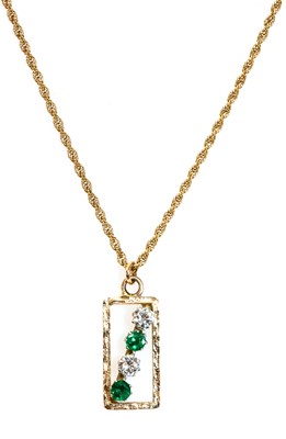 Lot 247 - A gold diamond and emerald pendant, c.1970