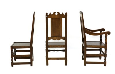 Lot 459 - A set of twelve 17th century style oak panel seat dining chairs